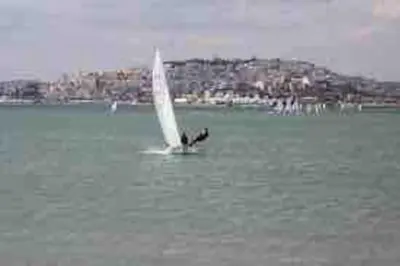 a person on a sail boat in the water at Paleo Faliro Athens fully equipped 2 bedrooms 90 sqm big apartment 200m to Free beach in Athens