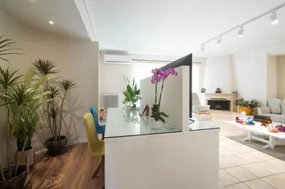 a living room with a vase of flowers on a counter at Vicky's Sky Loft in Piraeus
