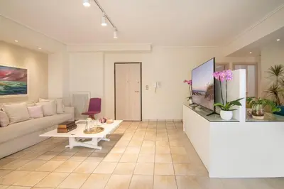 a living room with a couch and a tv at Vicky's Sky Loft in Piraeus