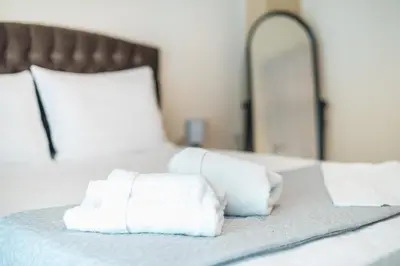 a pile of towels sitting on top of a bed at Stylish City Apartment by CloudKeys in Athens