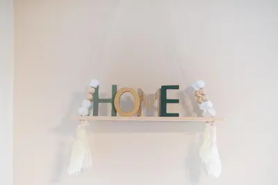 a wooden sign with the word one hanging from a window at Stylish City Apartment by CloudKeys in Athens