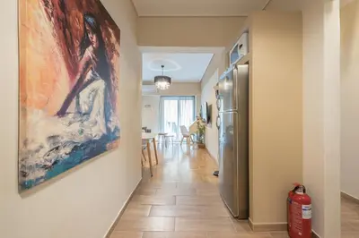 a hallway with a painting hanging on a wall at Stylish City Apartment by CloudKeys in Athens