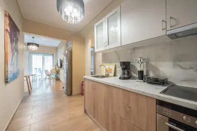 a kitchen with a sink and a counter top at Stylish City Apartment by CloudKeys in Athens