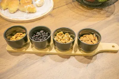 four bowls of nuts and dried fruits on a tray at Modern and Luxury apartment in Athens
