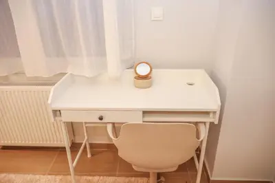 a desk with a candle and a chair in a room at Modern and Luxury apartment in Athens