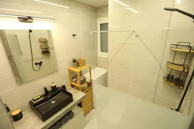 a bathroom with a sink and a shower at Modern and Luxury apartment in Athens
