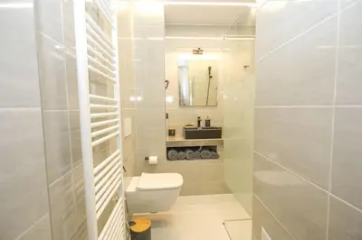 a white bathroom with a toilet and a sink at Modern and Luxury apartment in Athens