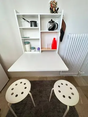 a white desk with two chairs in a room at apartment Alimos near the sea in Alimos