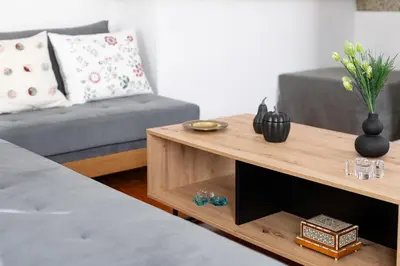 a living room with a couch and a coffee table at Athenian Getaway Villa in Plaka with Acropolis View by Athenian Homes in Athens