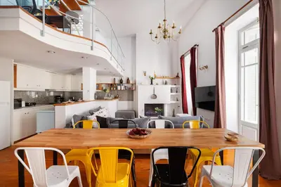a dining room with a wooden table and yellow chairs at Athenian Getaway Villa in Plaka with Acropolis View by Athenian Homes in Athens