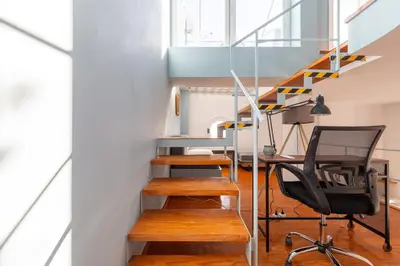 a room with stairs and a desk and a chair at Athenian Getaway Villa in Plaka with Acropolis View by Athenian Homes in Athens
