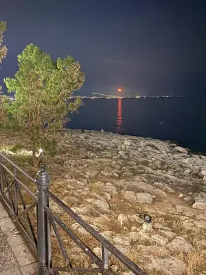 a view of a body of water at night at Mia's Seaside Penthouse - Panoramic View in Piraeus
