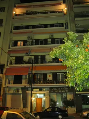 a tall building with a parking lot in front of it at Mia's Seaside Penthouse - Panoramic View in Piraeus
