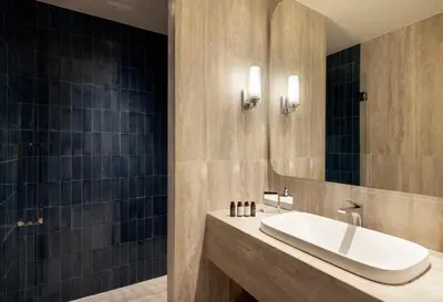 a bathroom with a sink and a mirror at Mitsis N'U Piraeus Port in Piraeus