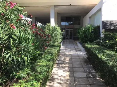 a walkway in front of a building with flowers at Vasos apartment in Athens