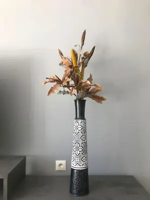 a black and white vase with flowers in it at Vasos apartment in Athens