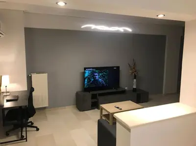 a living room with a flat screen tv on a wall at Vasos apartment in Athens