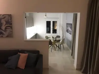 a living room and kitchen with a couch and a table at Vasos apartment in Athens