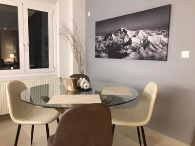 a dining room with a glass table and chairs at Vasos apartment in Athens