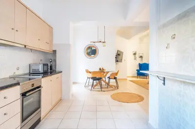 a kitchen and dining room with a table and chairs at Majestic 2 Glyfada in Athens