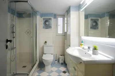 a bathroom with a toilet and a sink and a shower at Majestic 2 Glyfada in Athens
