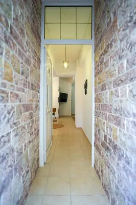 a hallway with a brick wall at Majestic 2 Glyfada in Athens