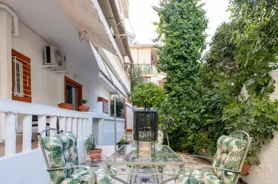 a glass table and chairs on a balcony at Majestic 2 Glyfada in Athens