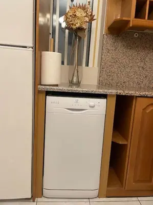 a kitchen with a white dishwasher next to a counter at DM Apartment 1 in Athens