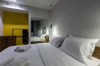 a bedroom with a large white bed with white pillows at Zambelis Luxury Home Spa in Athens