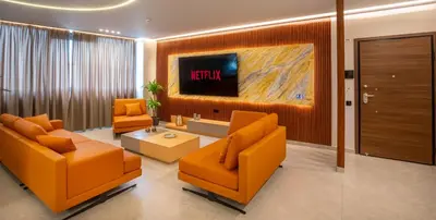 a living room with orange furniture and a tv at Zambelis Luxury Home Spa in Athens