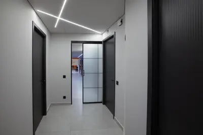 a hallway with black doors and white walls at Zambelis Luxury Home Spa in Athens