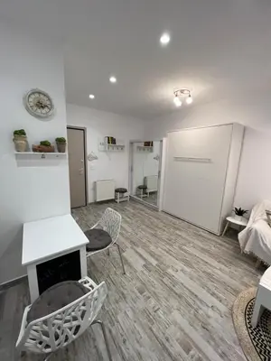 a living room with a fireplace and a bed at Selenity studio(close to two metro stations) in Piraeus