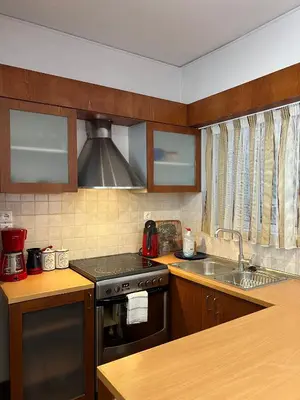 a kitchen with a stove and a sink at Machi's Apartment in Markopoulo