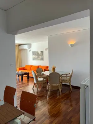 a living room with a table and chairs and a couch at Machi's Apartment in Markopoulo