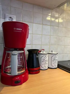 a red blender sitting on top of a kitchen counter at Machi's Apartment in Markopoulo