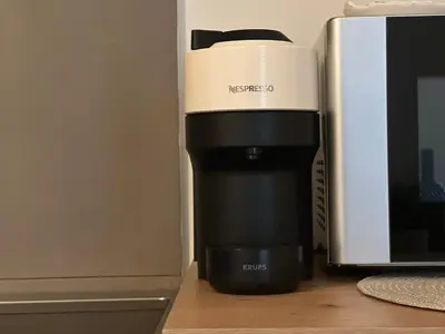 a coffee maker sitting next to a microwave at Cozy Faliro home in Piraeus