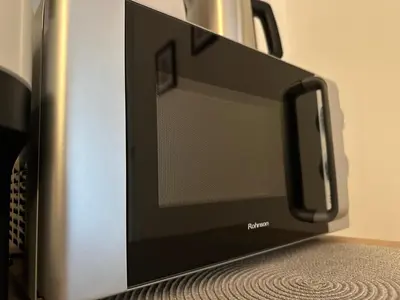 a toaster oven sitting on top of a table at Cozy Faliro home in Piraeus