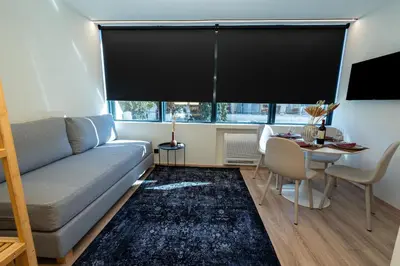 a living room with a couch and a table at Athens Airport Living spaces in Spáta