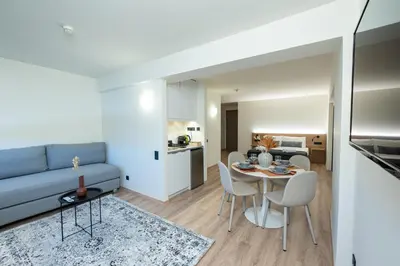 a living room with a couch and a table and chairs at Athens Airport Living spaces in Spáta