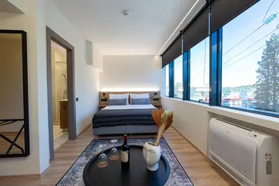 a bedroom with a bed and a table in a room at Athens Airport Living spaces in Spáta