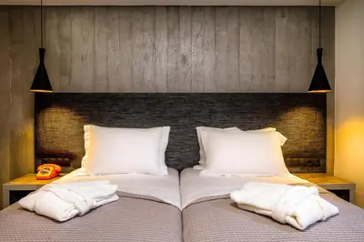 a bedroom with a bed with white pillows at 360 Degrees in Athens