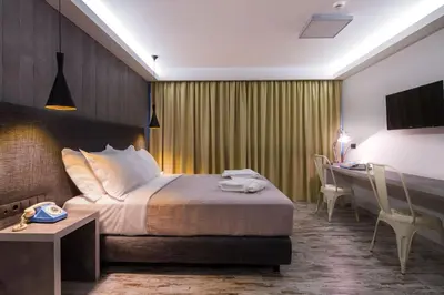 a hotel room with a bed and a desk and a computer at 360 Degrees in Athens