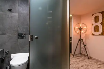 a bathroom with a shower with a toilet and a camera at 360 Degrees in Athens