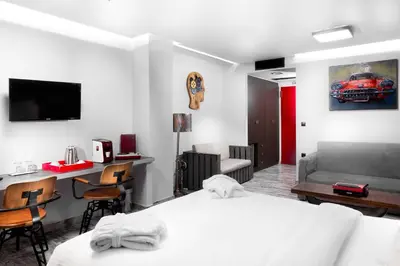 a bedroom with a bed and a desk and a couch at 360 Degrees in Athens