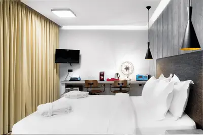 a hotel room with a bed and a desk at 360 Degrees in Athens