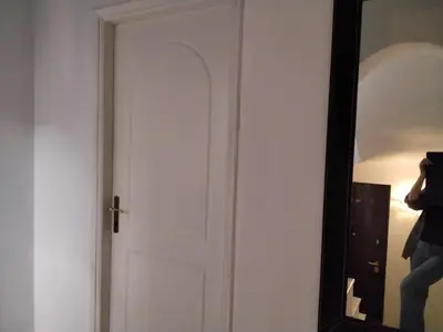 a person taking a picture of a door in a mirror at Peaceful oasis in Athens