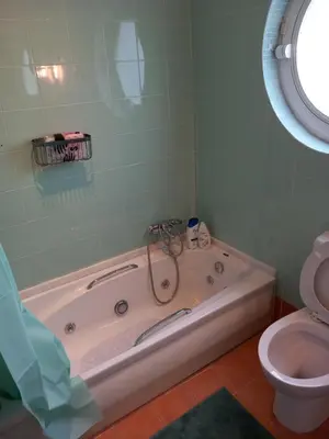 a bathroom with a tub and a toilet at pavlosloft in Leondárion