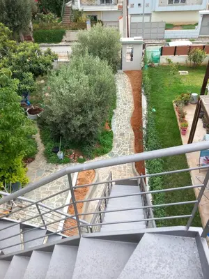 an overhead view of a stair railing and a garden at pavlosloft in Leondárion