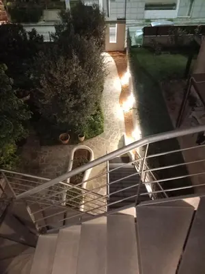 a stairway leading to a house with lights on it at pavlosloft in Leondárion