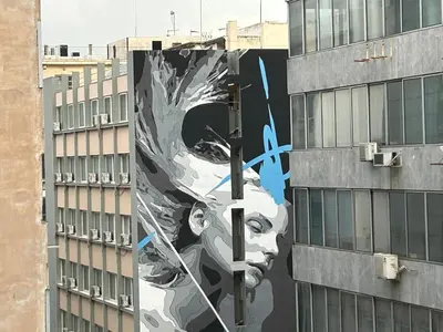 a mural of a face on the side of a building at PORT TWINS SUITES No1 in Piraeus